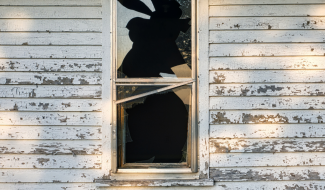 A house with a broken window link to Housing Code page